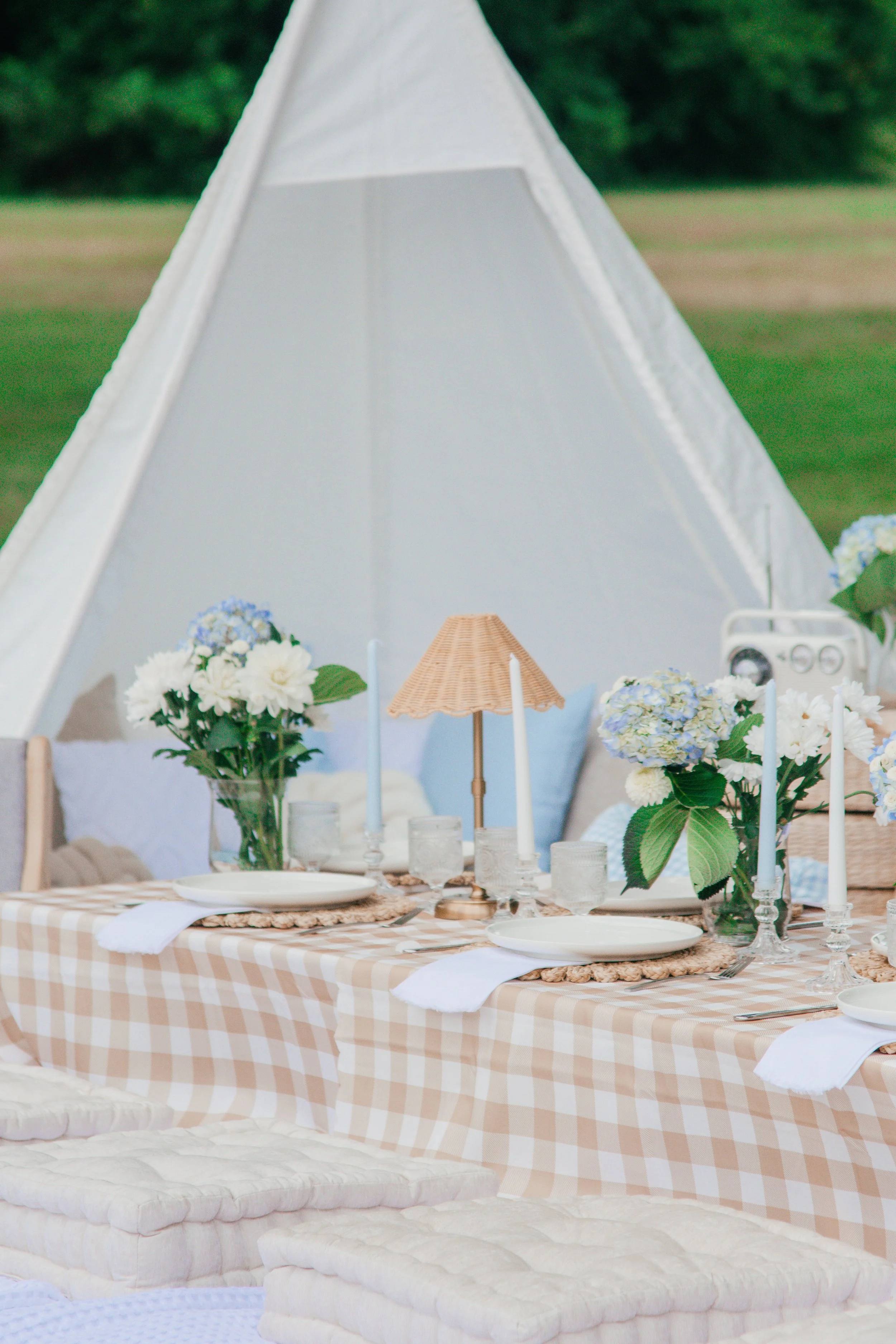 White boho teepee beside a picnic table