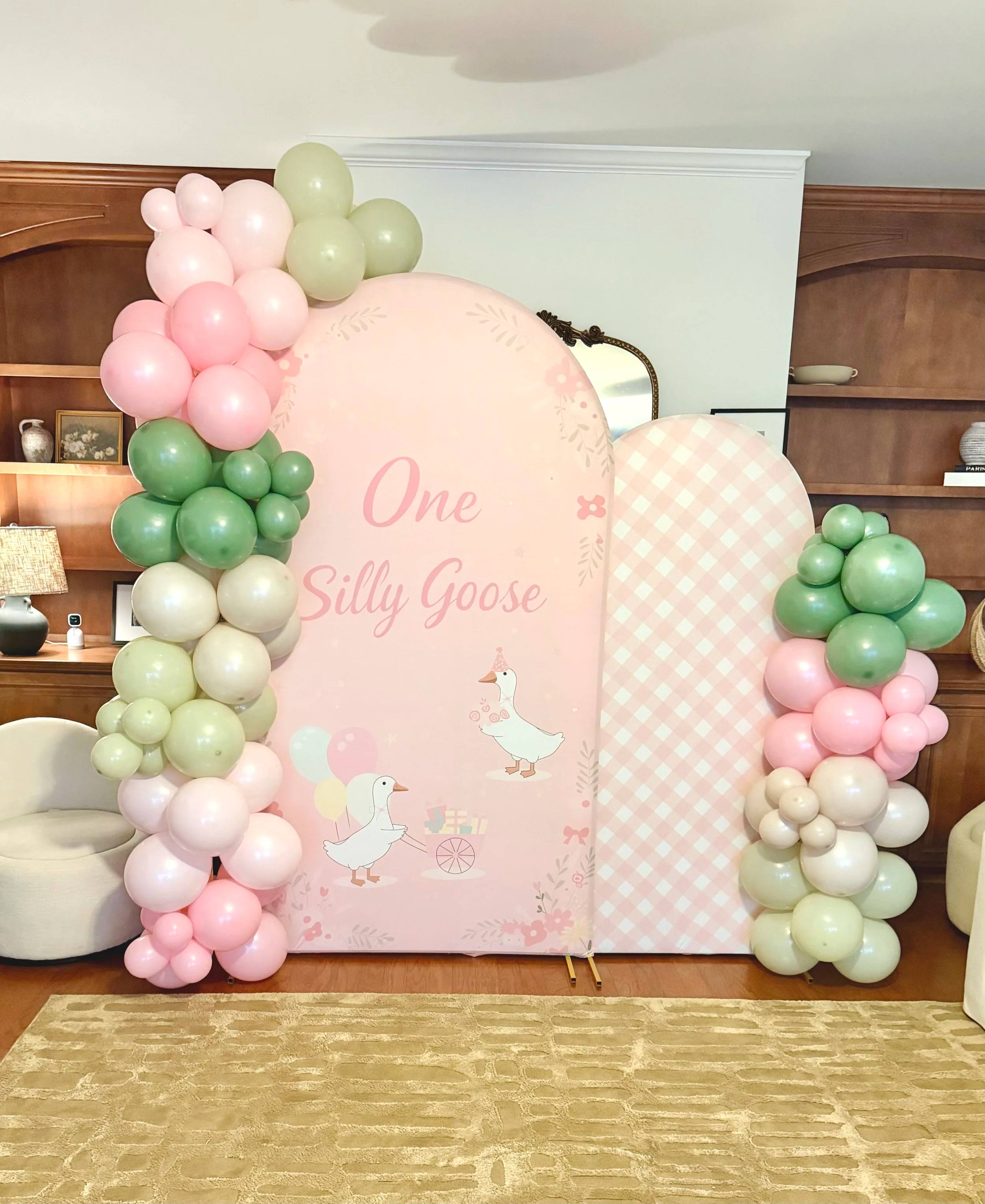 Pink and cream backdrop reading One Silly Goose