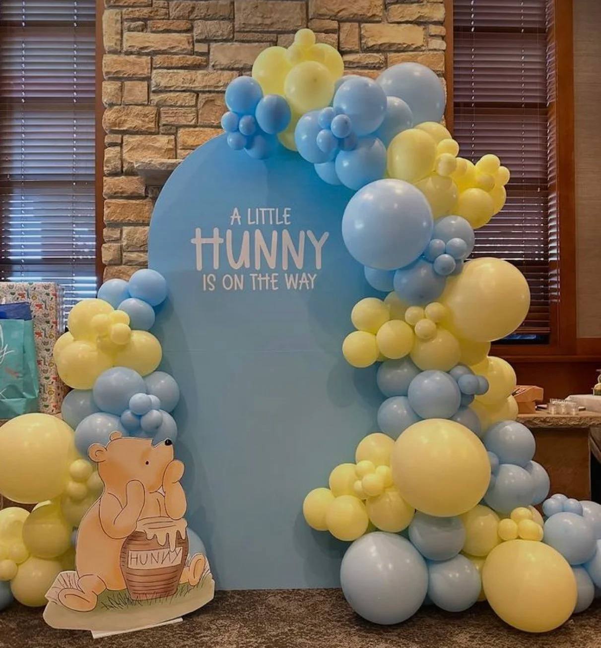 Blue and yellow backdrop reading A Little Hunny Is On The Way