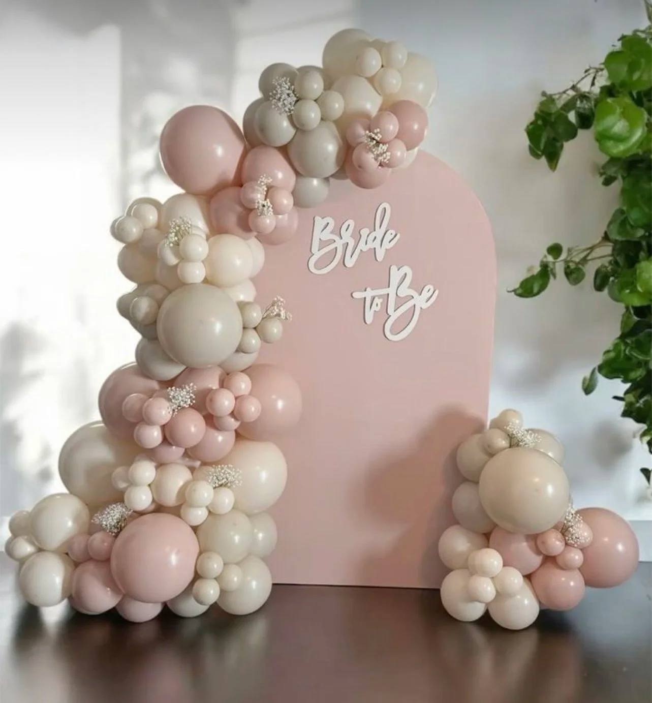 Bride to Be lettering on a blush arch with balloon garland